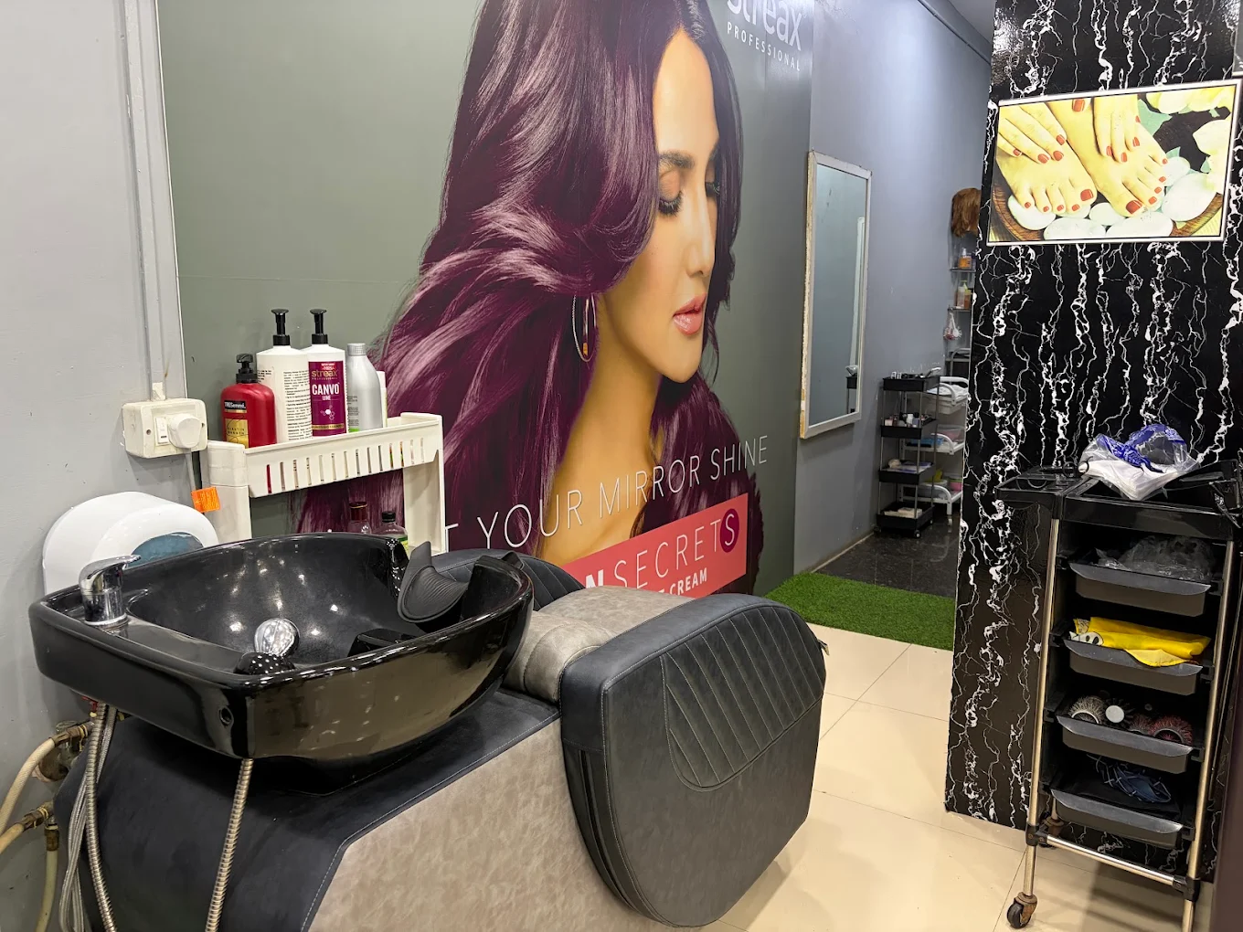 Interior of IFA Unisex Salon in Devanahalli, a premium black and gold styling space